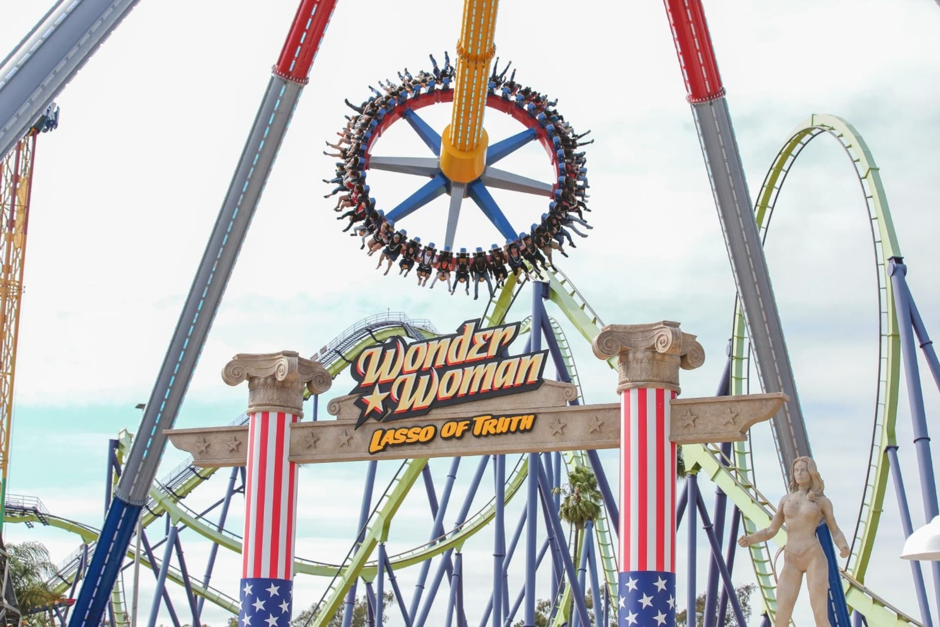Guests experiencing the high flying thrills of the WONDER WOMAN Lasso of Truth ride at Six Flags Discovery Kingdom.