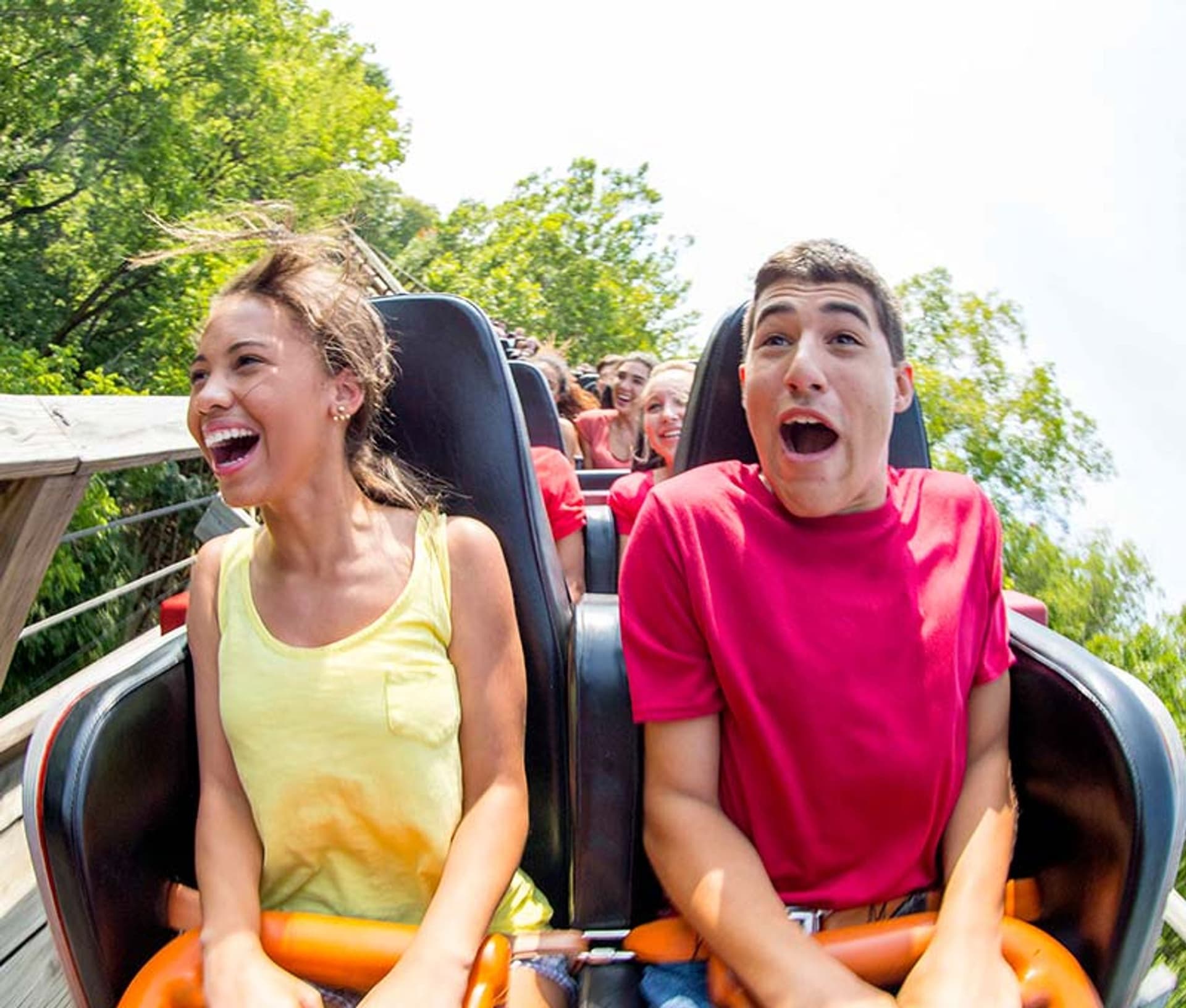woman and man riding a roller coaster
