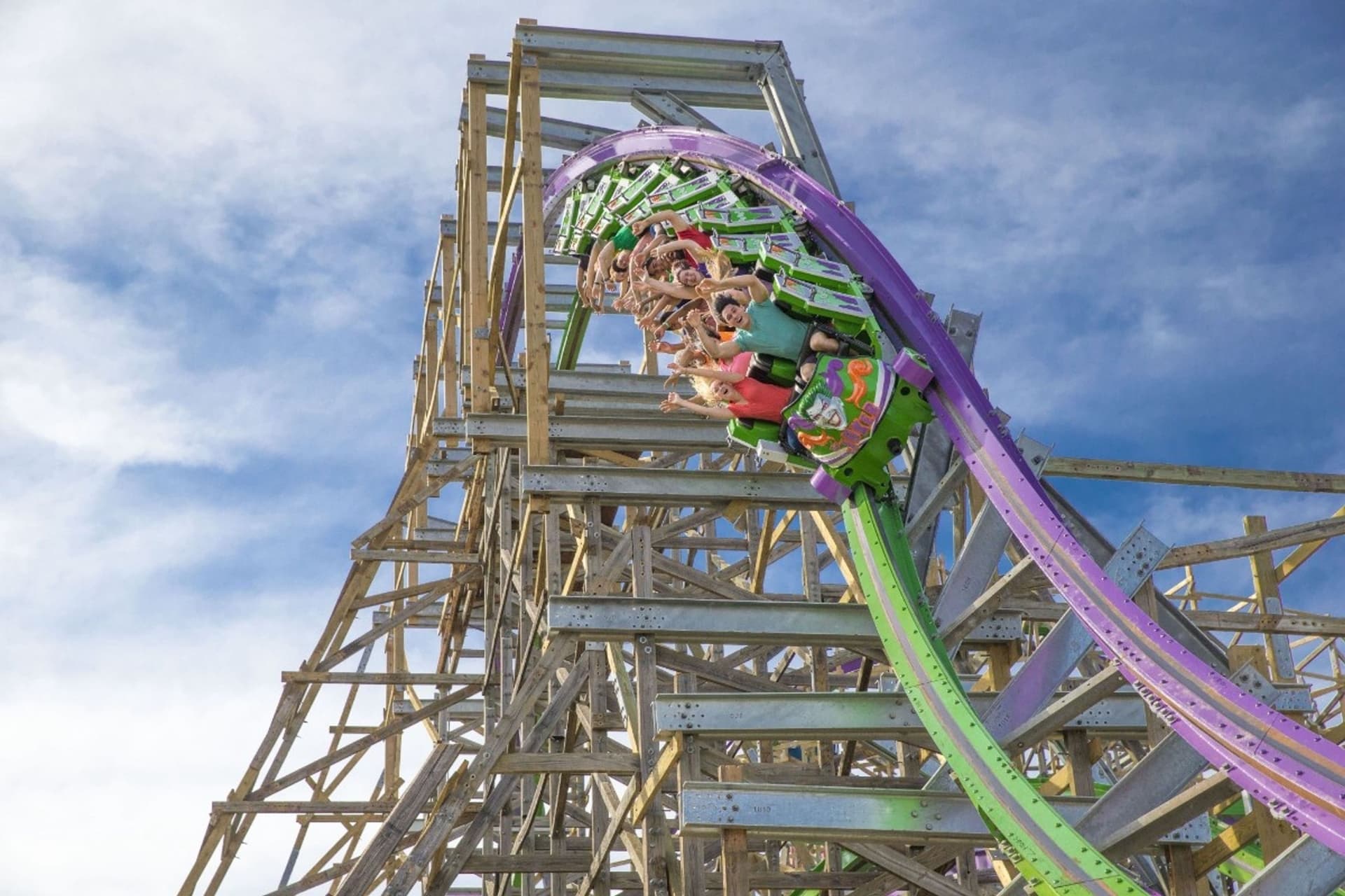 Guests coming out of a corkscrew of THE JOKER roller coaster  leading into a descent and more thrills. 